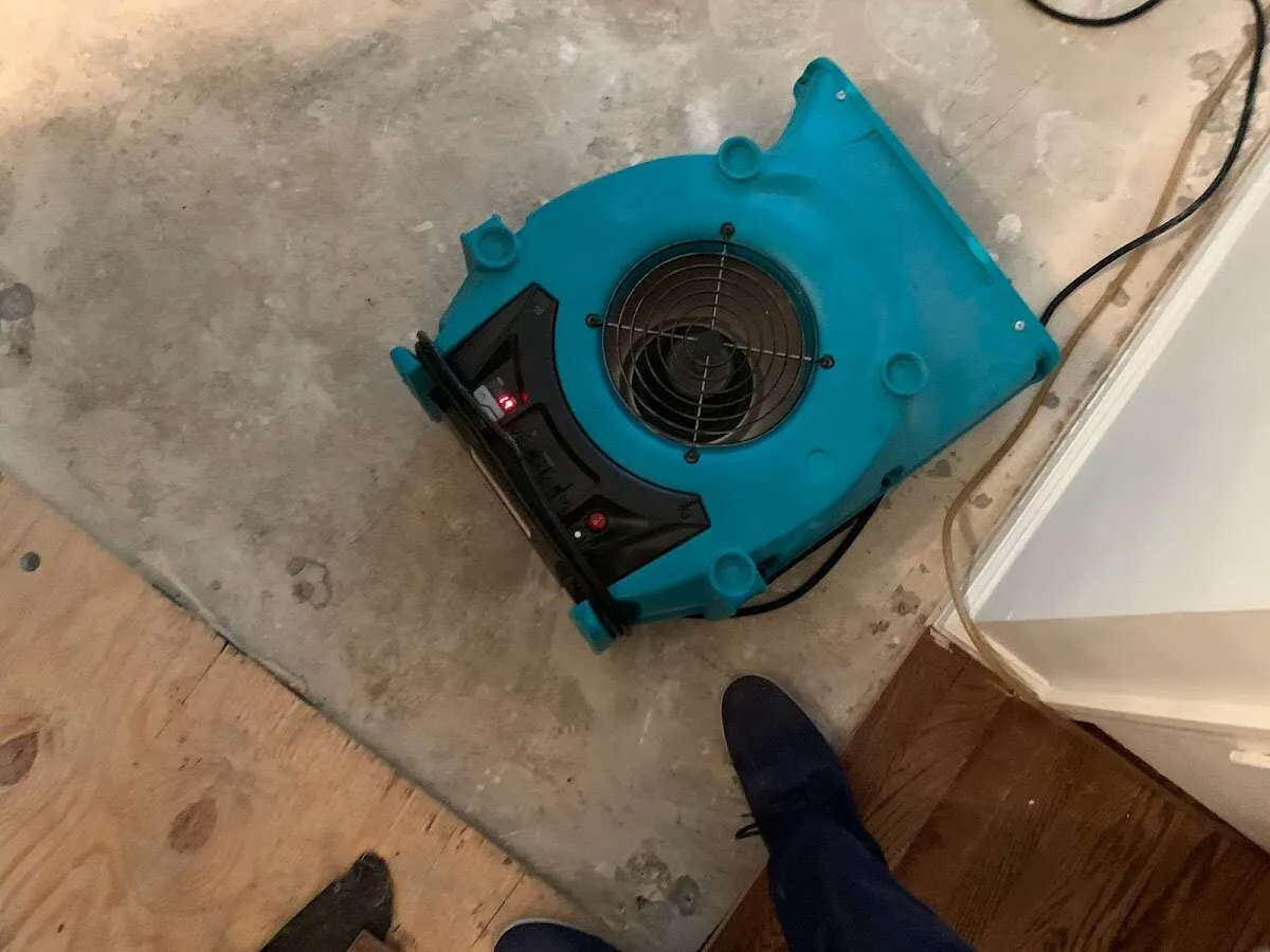 Air mover drying subfloor during Commercial Water Damage Restoration in Richmond Hill